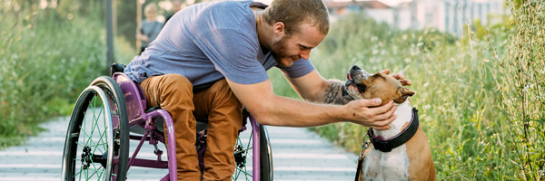 man in wheelchair with dog